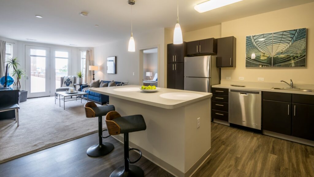 A kitchen with a bar and two stools in it